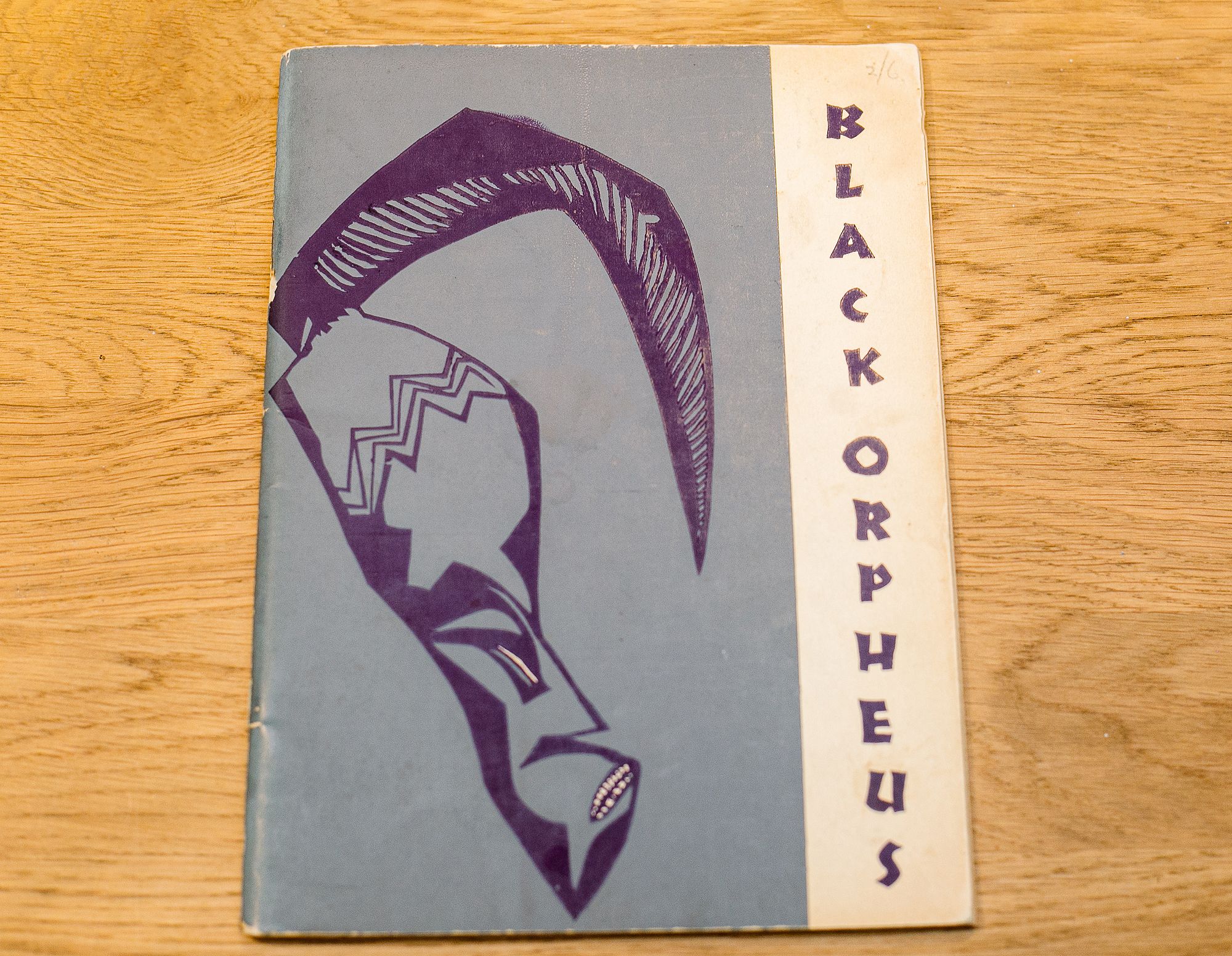 Cover of "BLACK ORPHEUS" featuring a stylized purple mask with a large horn on a light blue background.
