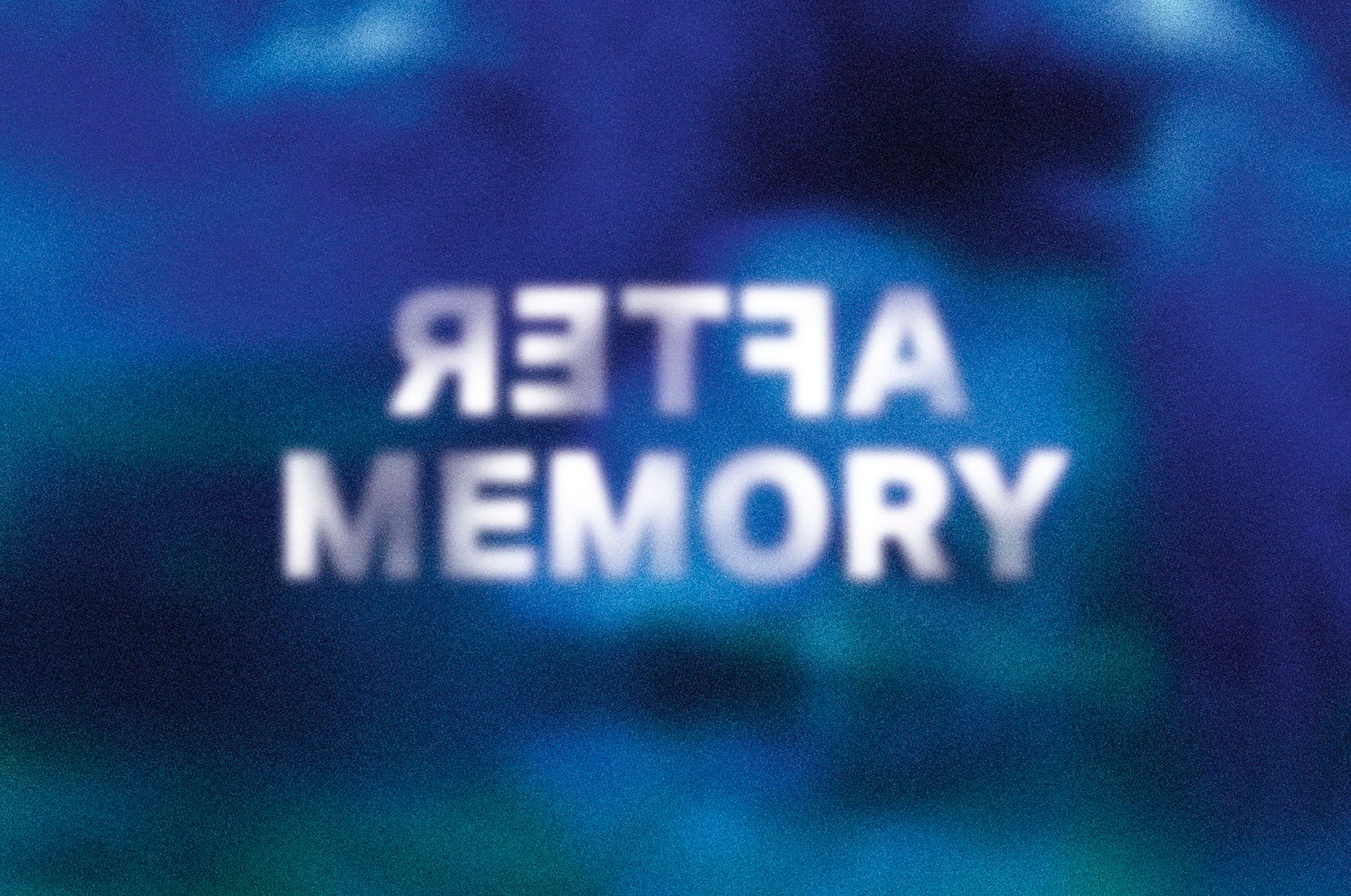 Blurred white text "AFTER" (mirrored) and "MEMORY" on a dark blue and green background.