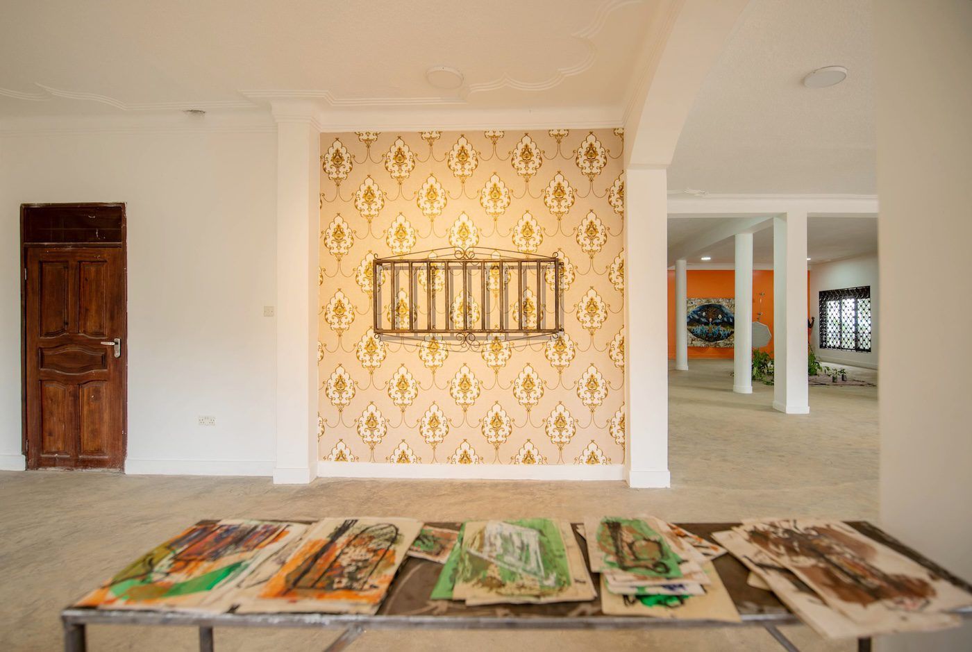 Hassan Issah, Lyrical Opulence, 2023, locally welded iron cage on wallpaper, variable dimensions and An old story, 2023, 52 works on paper on locally welded table at Silent Invasions: The Art of Material Hacking. Photo: Atiko Anthony
