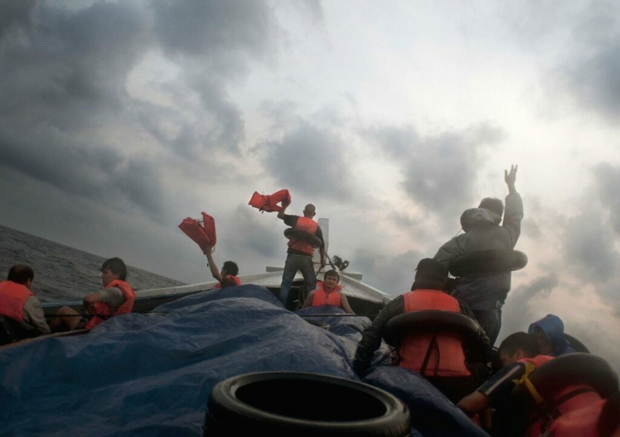 Barat Ali Batoor ’22 September, 2012, On the second day the boat is in trouble, taking on water - the passengers frantically wave their life jackets hoping to attract the attention of other boats.’ Courtesy of the artist