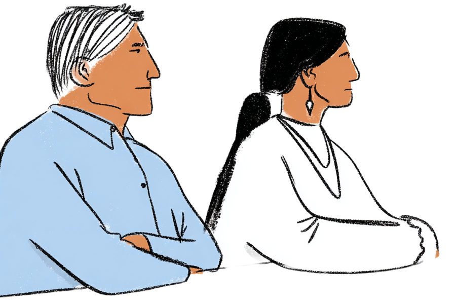 Two Native American people sitting next to each other at a table