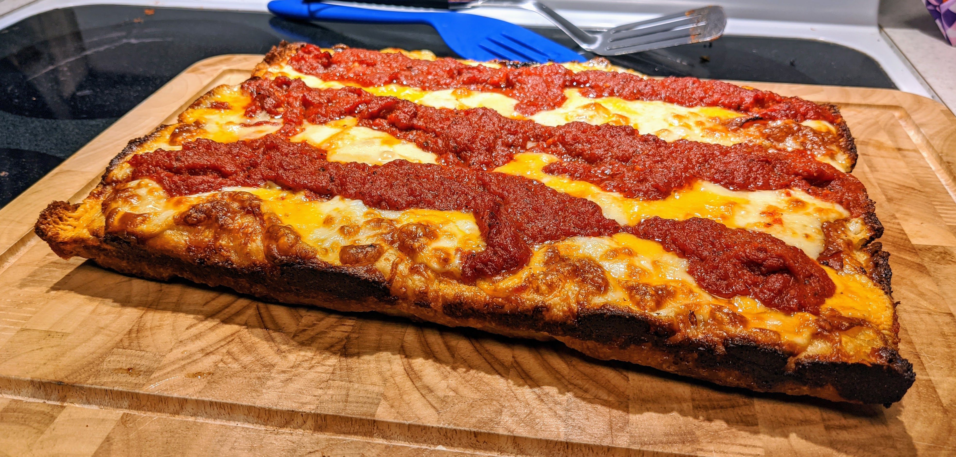 Close up of a Detroit pizza.