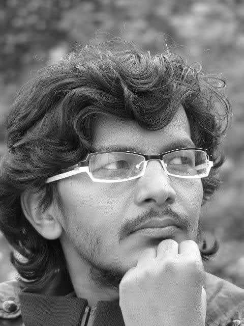 Black-and-white portrait of Saroj Khadgi, resting his chin on his hand