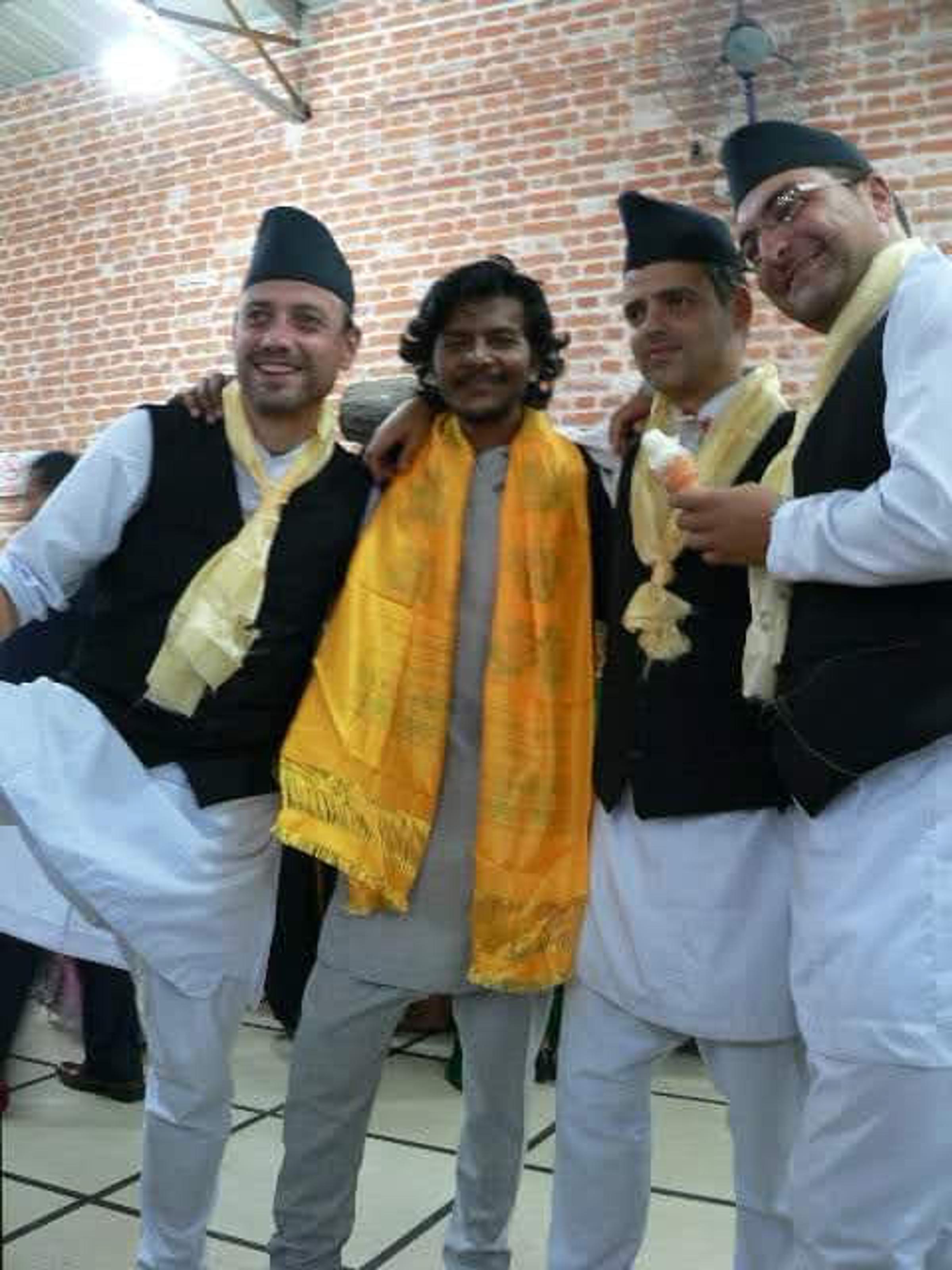 Saroj Khadgi with friends in traditional dress, wearing a yellow scarf
