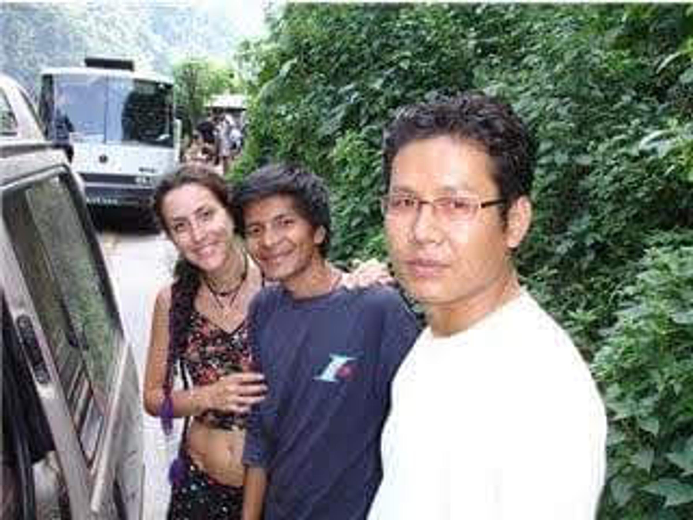 Saroj Khadgi with travellers beside a road
