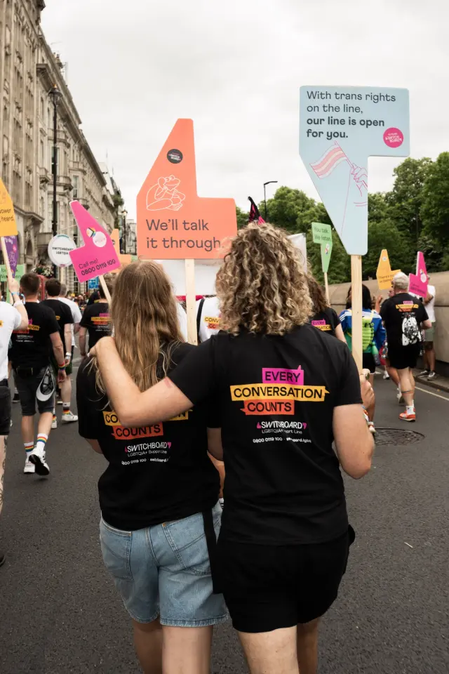 Volunteering walking in Pride in London parade.