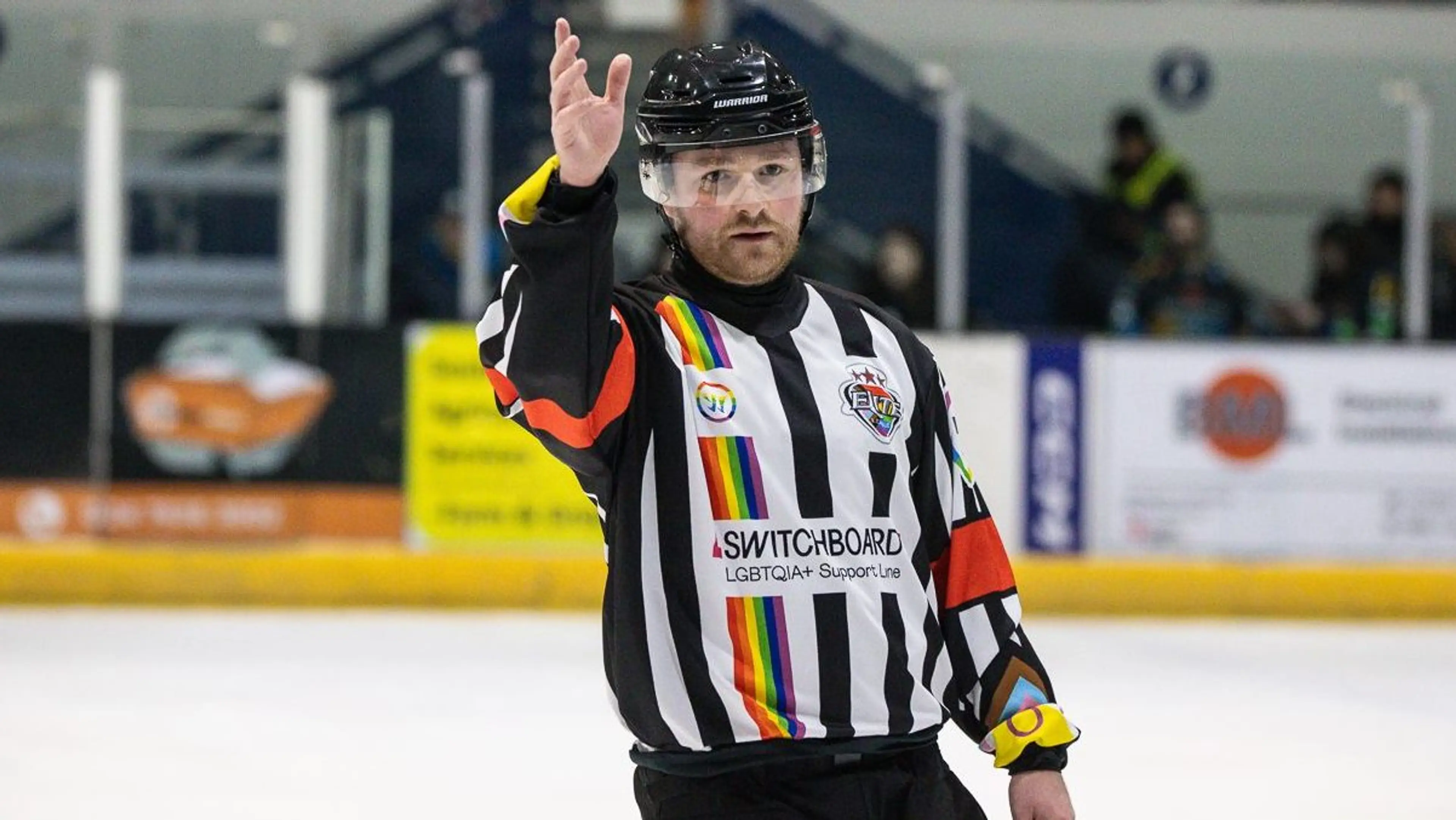 Ice hockey referee wearing pride kit with Switchboard logo