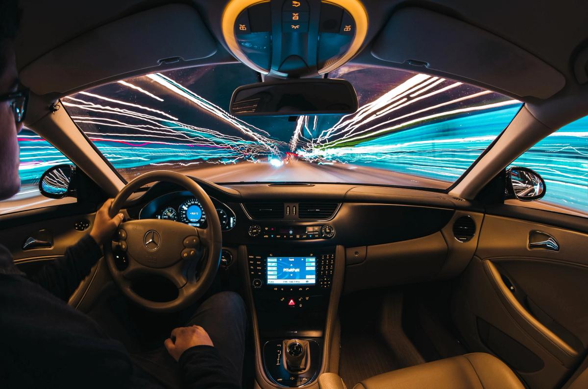 Looking through the windscreen of a car while driving through a tunnel