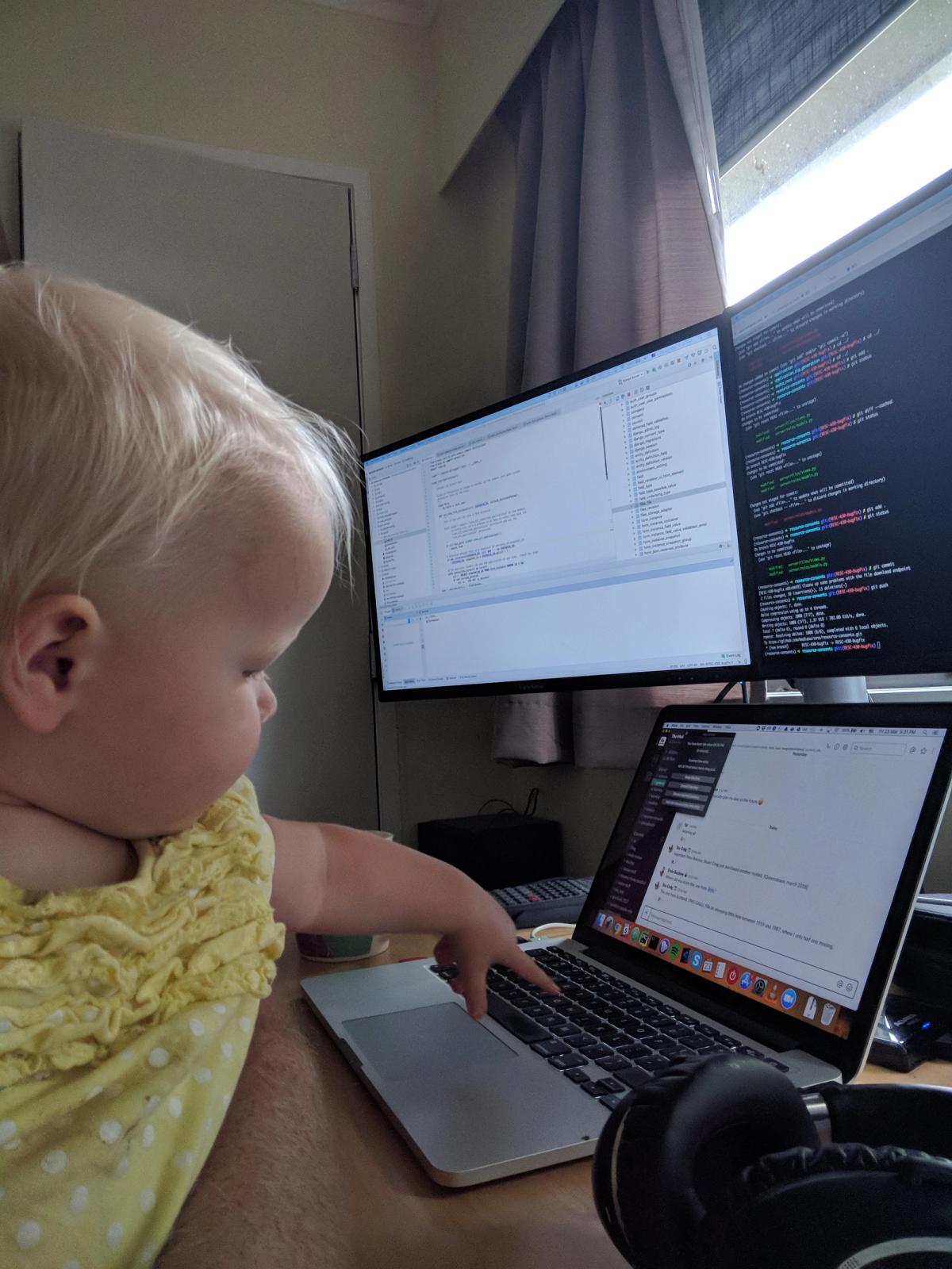 Baby reaching to press laptop keys