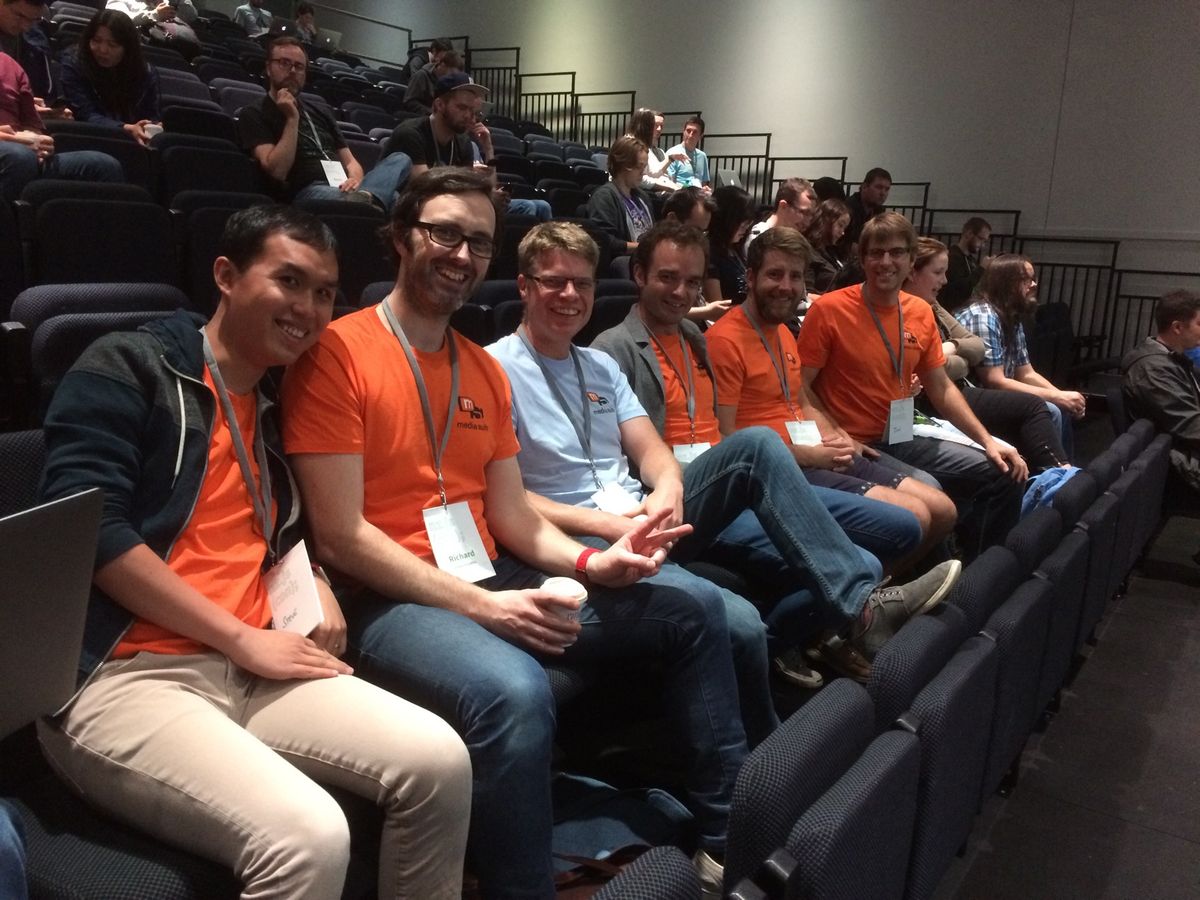 6 gentlemen from Media Suite sitting in a row in the conference theatre.