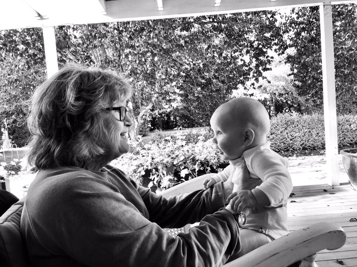 Grandmother holding baby, looking into eyes