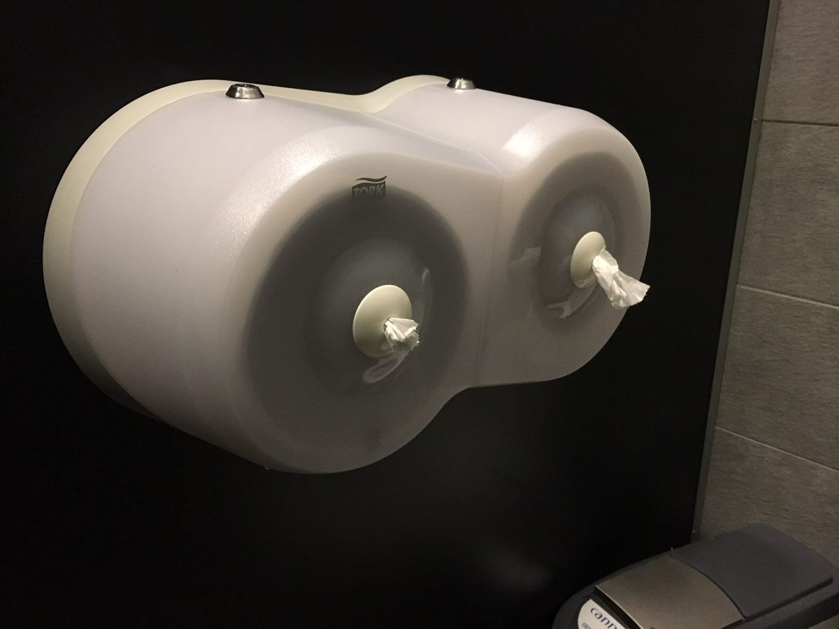 Toilet paper dispensers with paper that comes out the front of the unit