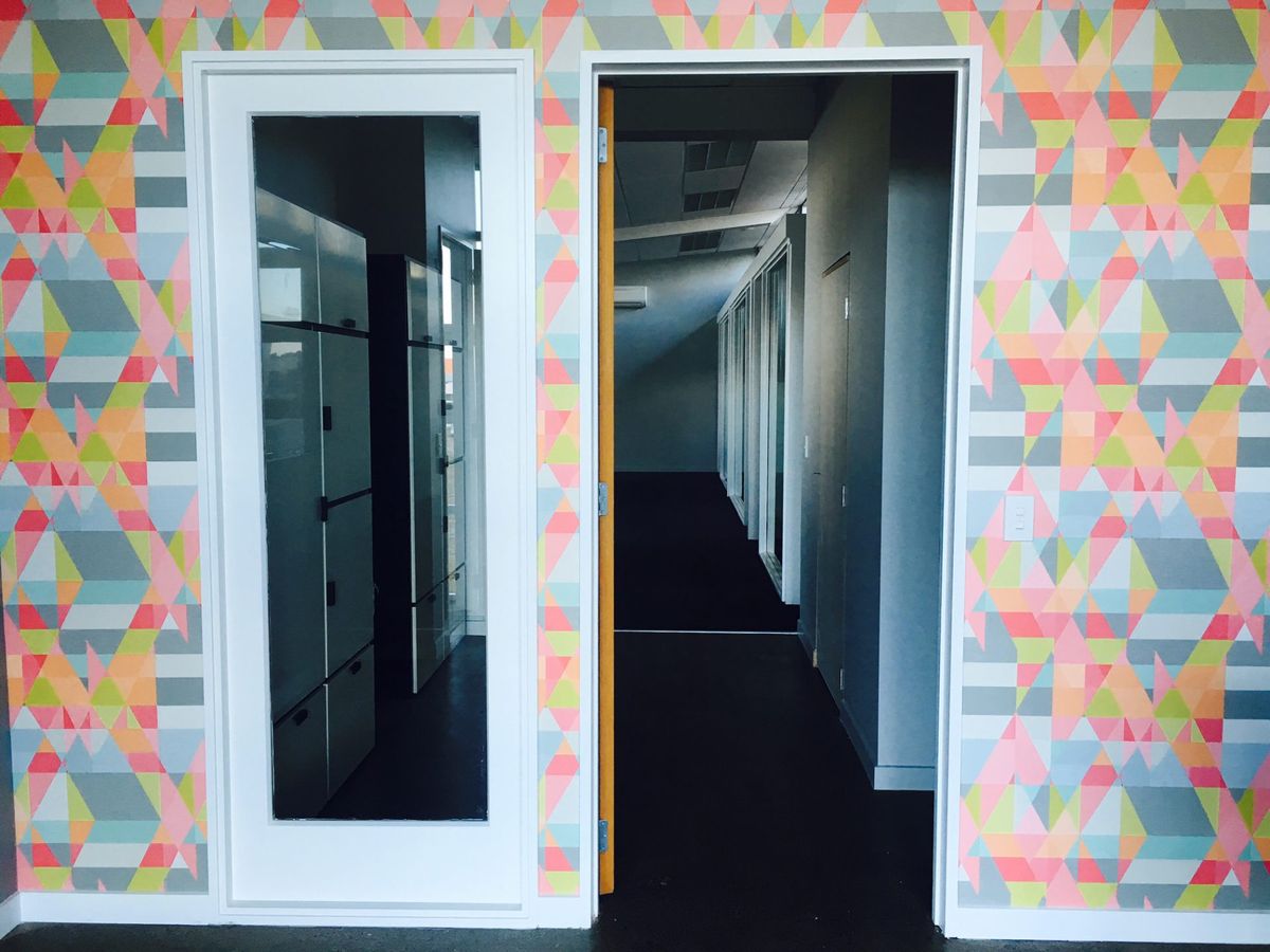 Patterned wall with open door and window