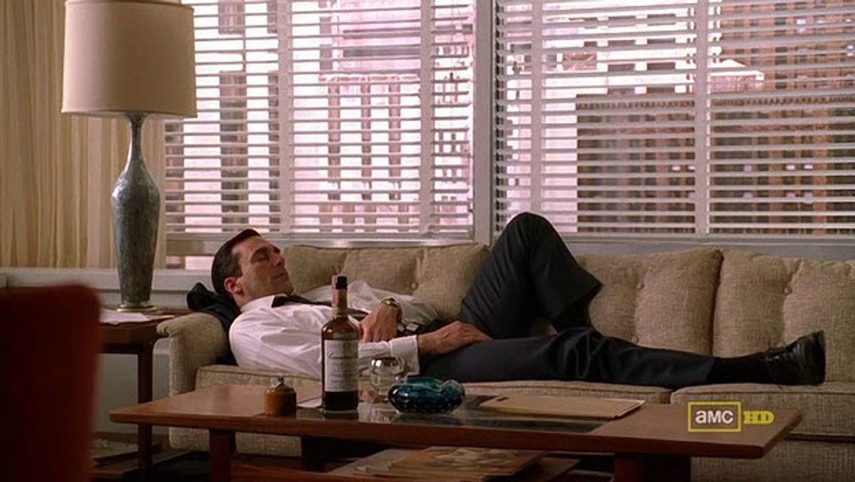 Don Draper asleep with whisky and ashtray