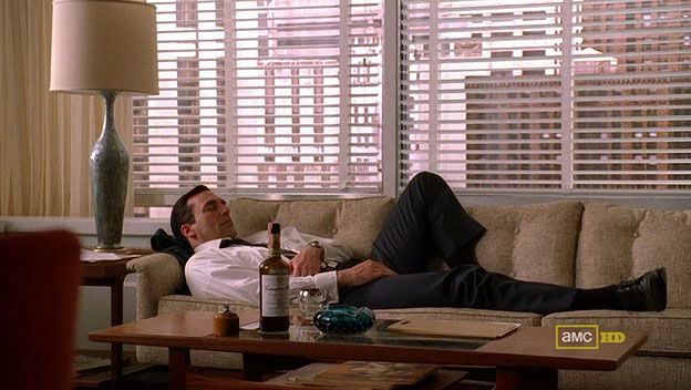 Don Draper asleep with whisky and ashtray