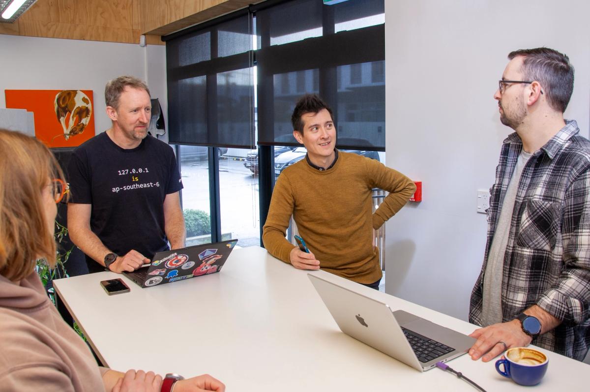 Group of people discussing project around a table