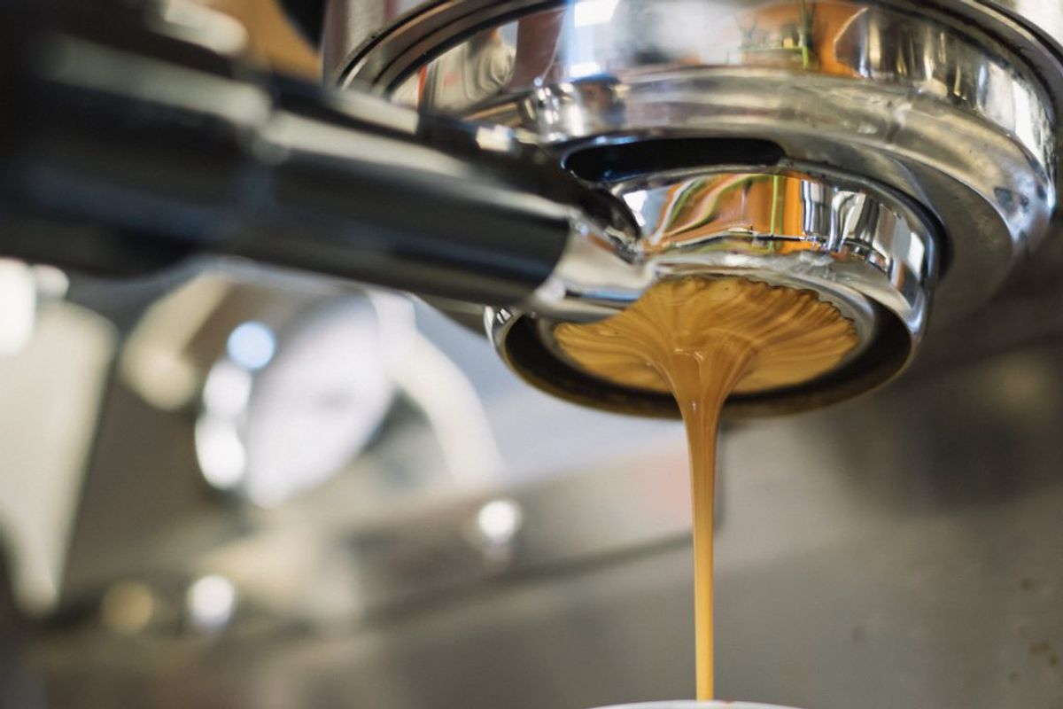 Espresso coffee running through portafilter