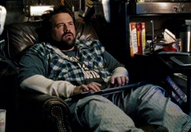 Man in a reclining leather armchair with a computer keyboard on his lap