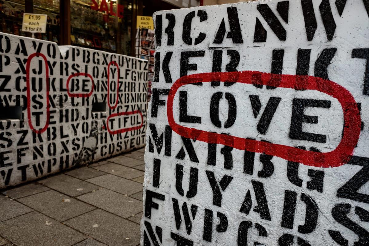 Street word puzzle with “love” and “just be you tiful”