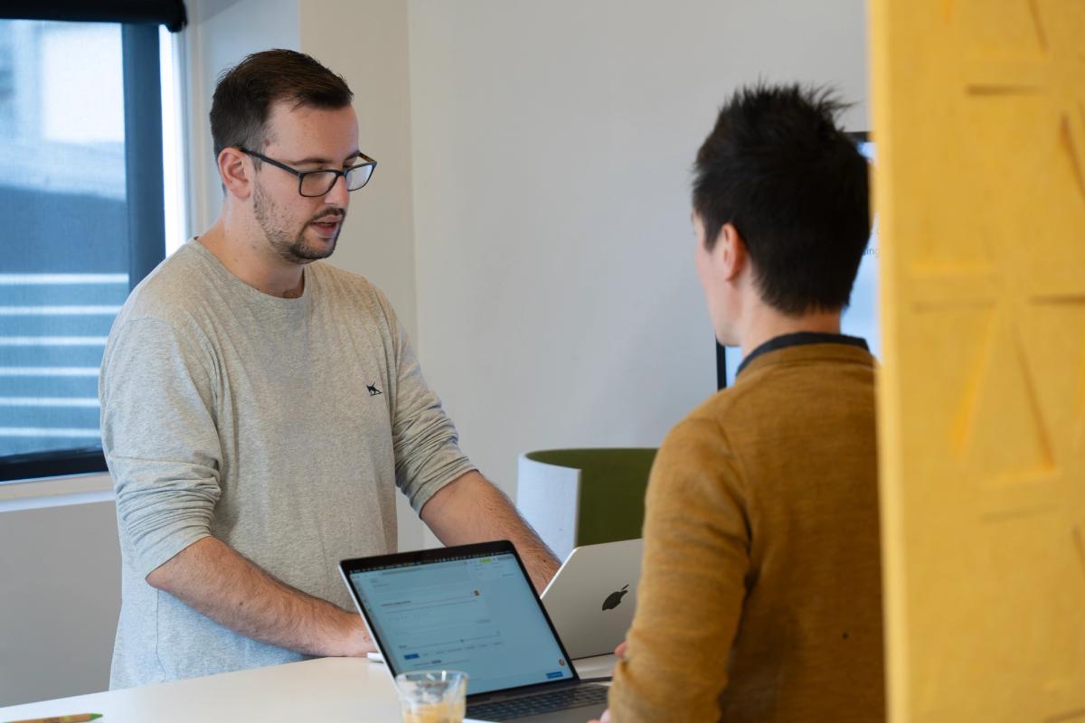 Two people discussing project around a table