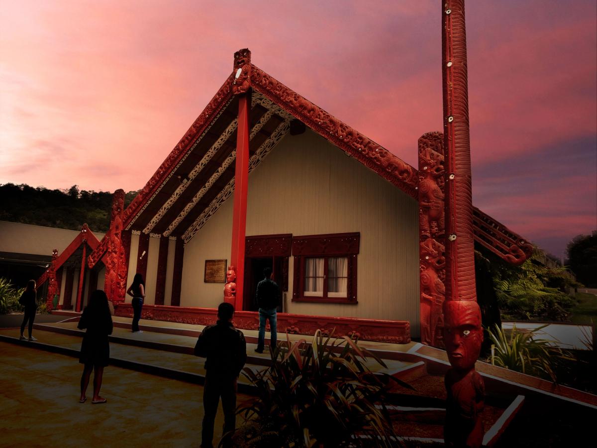 Marae at night with people silhouetted standing in front