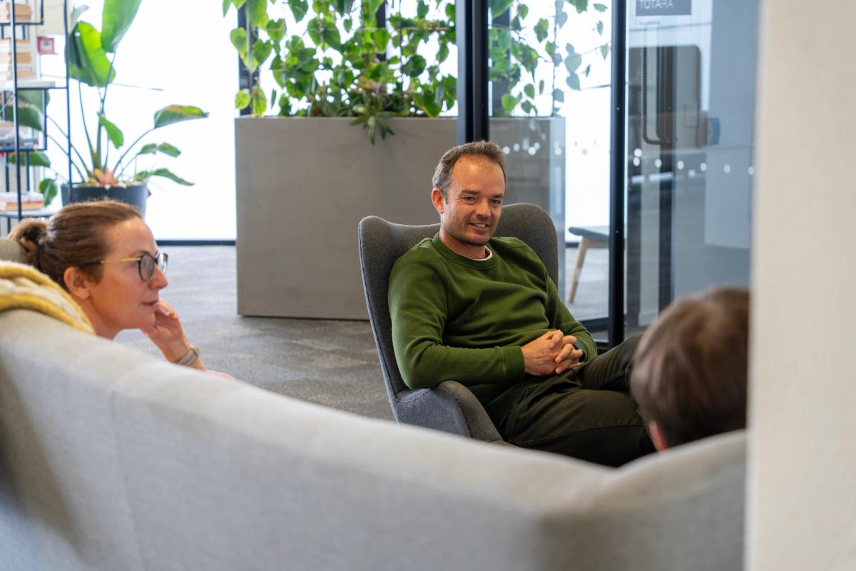 Group of people sitting on couches discussing ideas