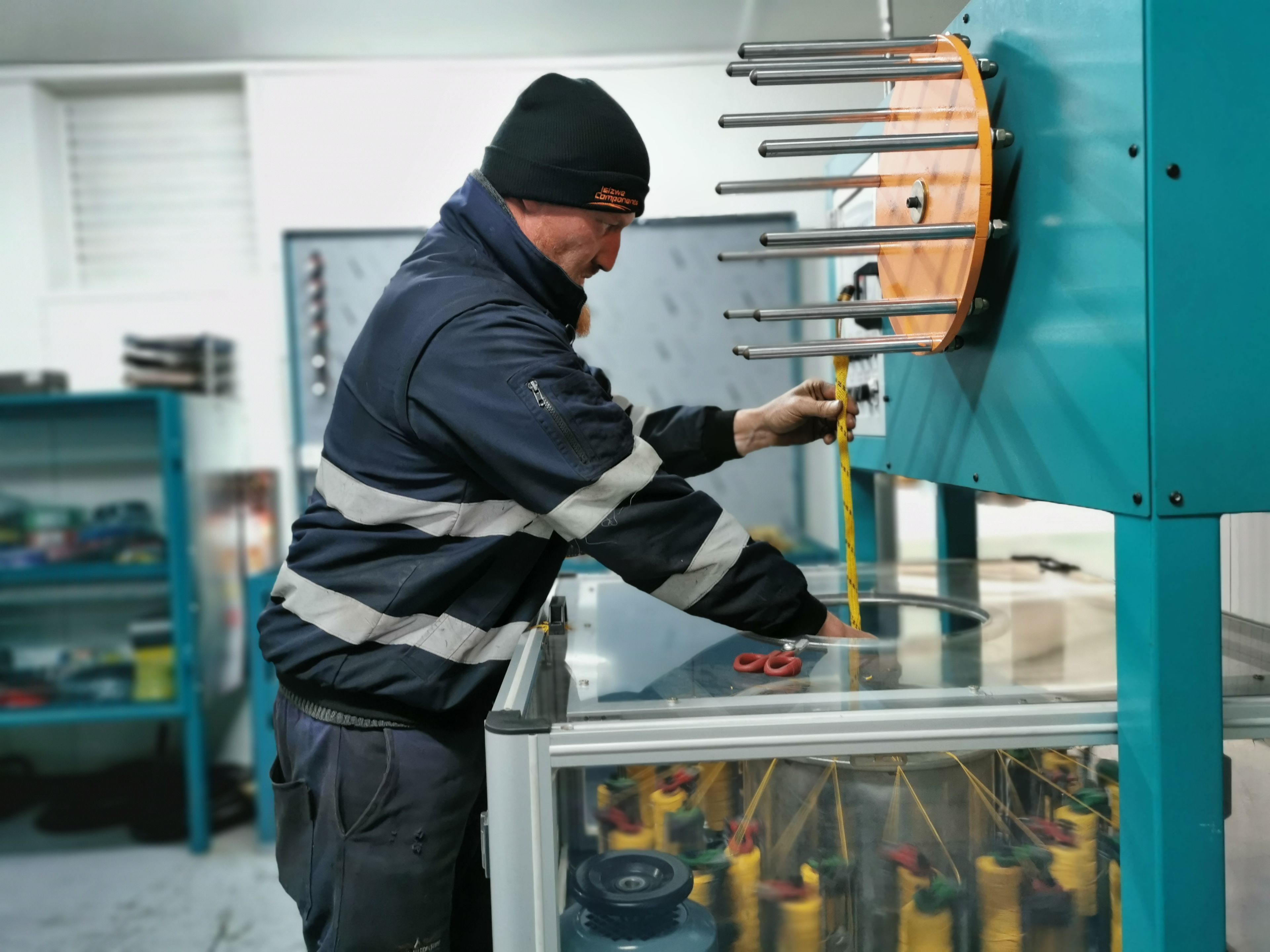 a man is working on a machine in a factory .