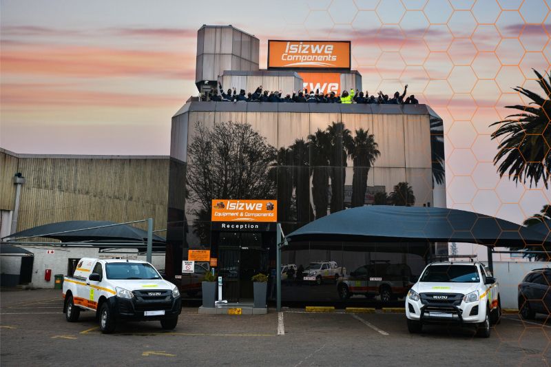 a building with a lot of cars parked in front of it .