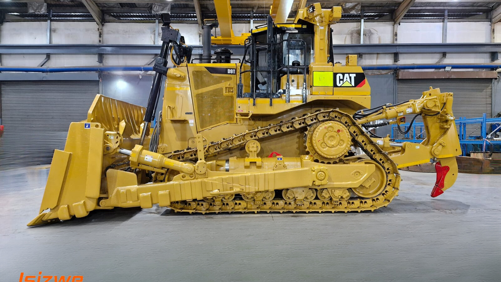 a large yellow cat bulldozer sits in a warehouse