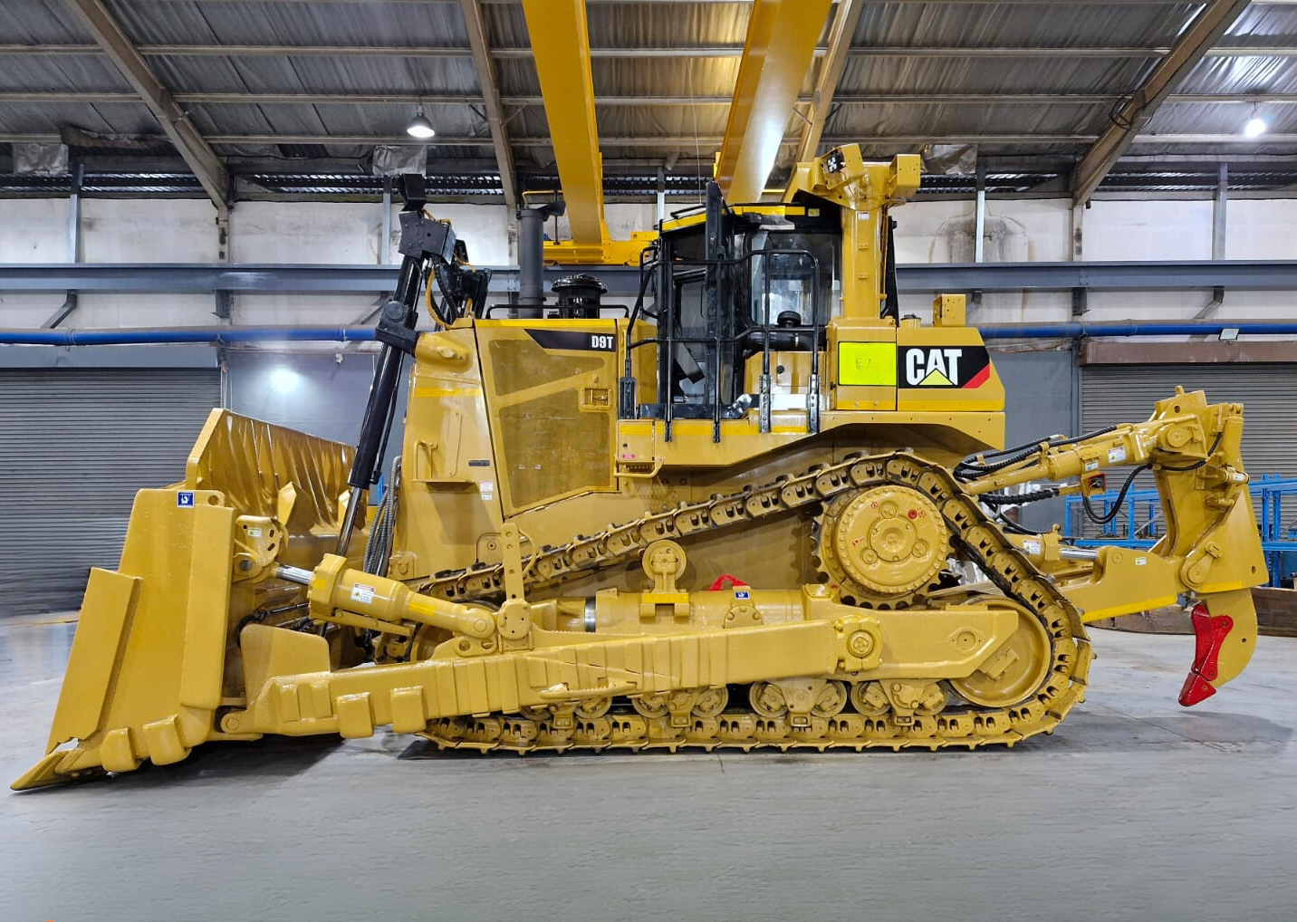 a large yellow cat bulldozer sits in a warehouse