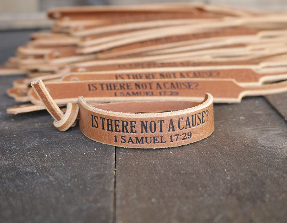Tan engraved leather bracelets reading “Is There Not a Cause? 1 Samuel 17:29”
