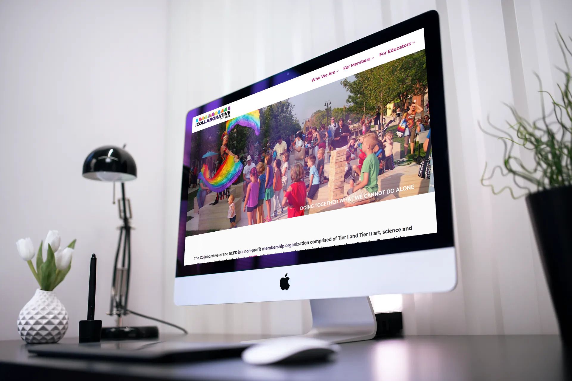 The Collaborative of the SCFD homepage shown on an iMac, with a colorful festival hero image