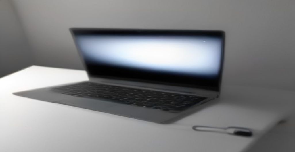 AI-generated cover: A sleek, ultra‑thin grey laptop with a 14‑inch OLED display open on a minimalist desk, highlighting its fanless design and magnesium‑aluminum chassis, soft studio lighting, no logo