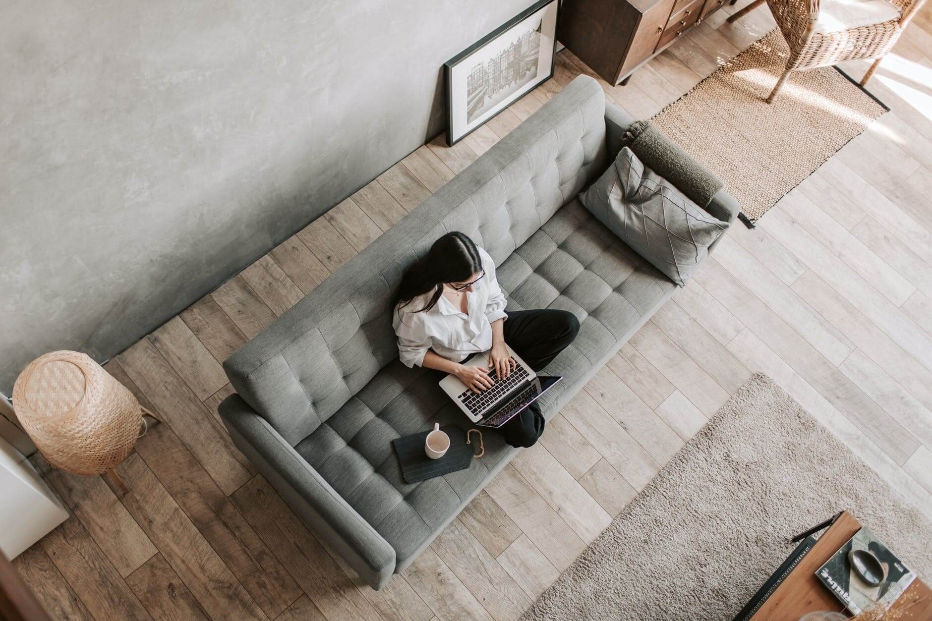 Woman working on her laptop on the sofa