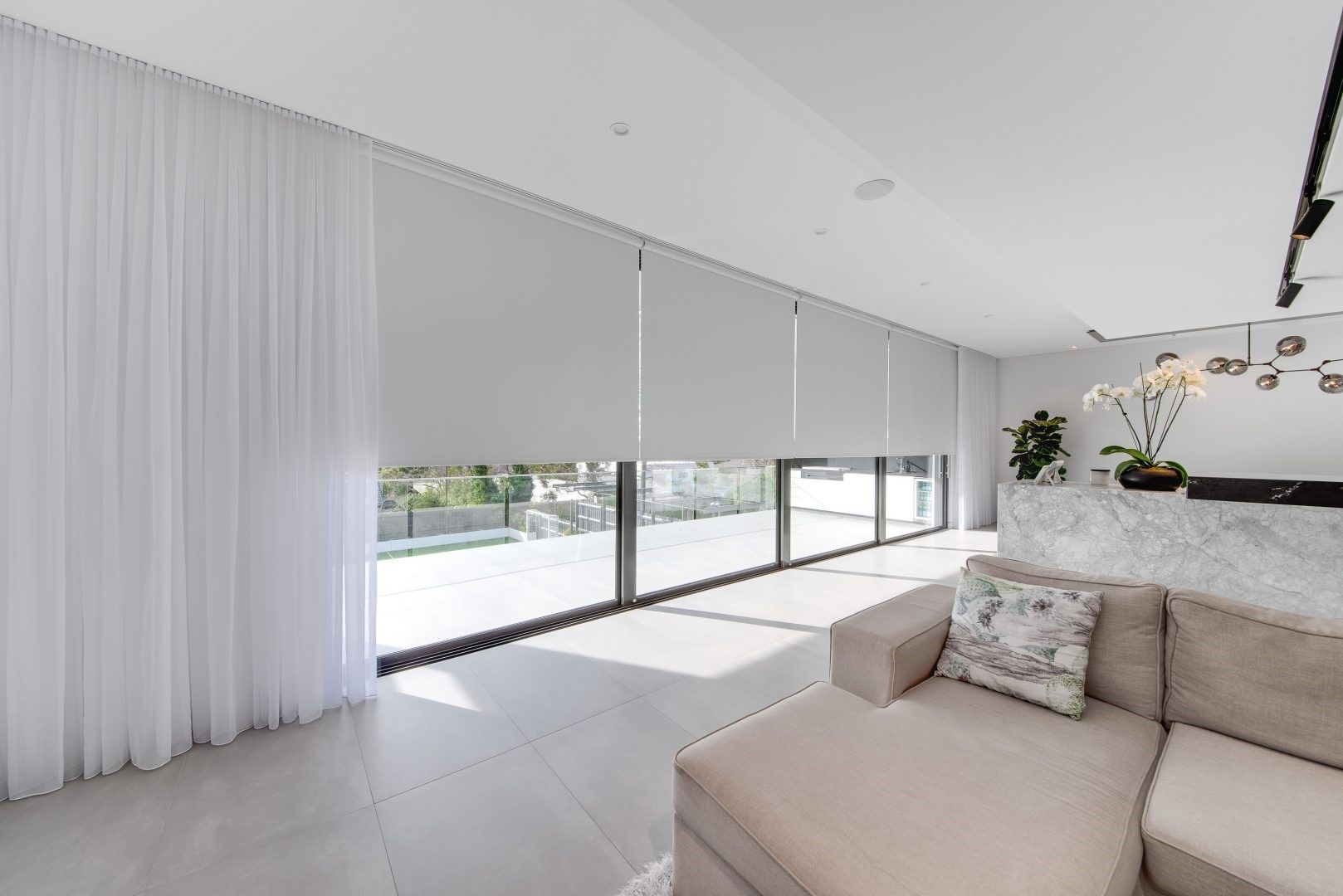 beige sofa and white curtains in living room