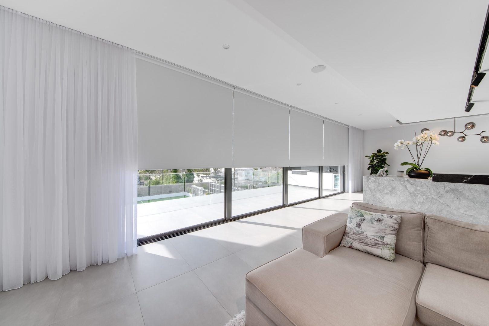 beige sofa and white curtains in living room
