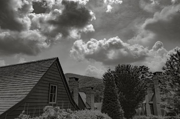 Cottage home in front of clouds