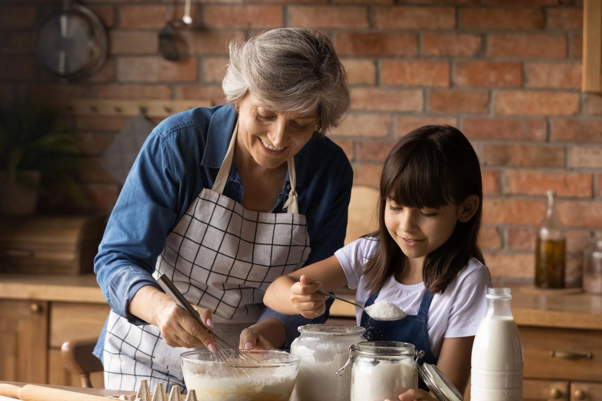 woman helping child in a kitchen