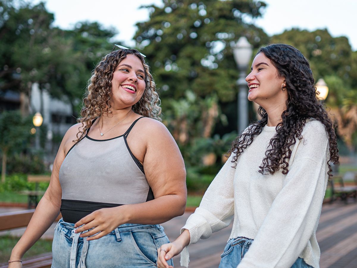 two women walking and smiling