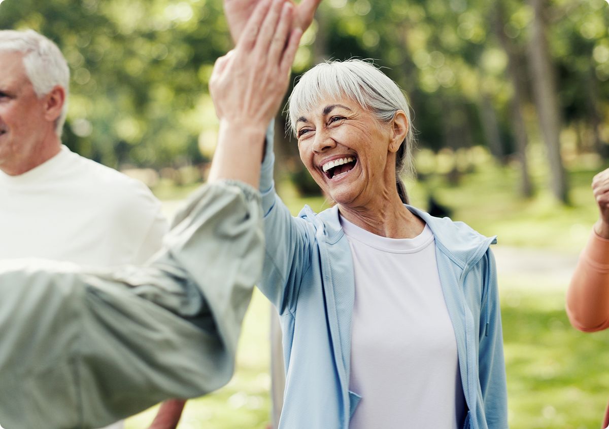 women smiling high fiving