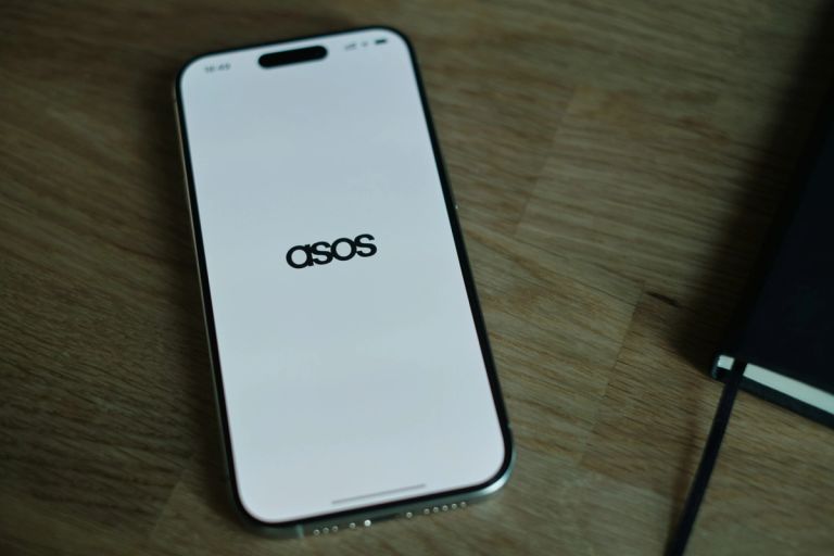 Phone with brand logo on it laying on a desk