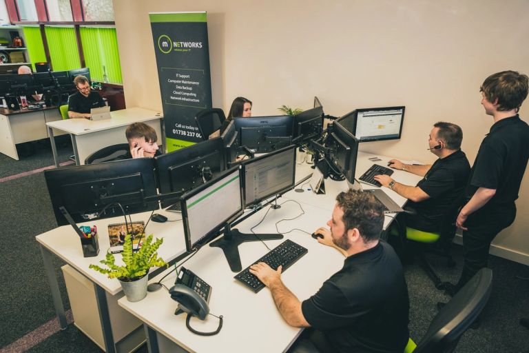 Photo of the m3 Networks team at work in the office