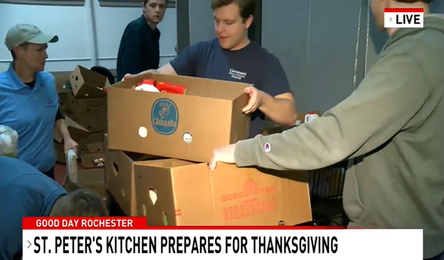 Live Good Day Rochester photo of four people getting boxes of food ready