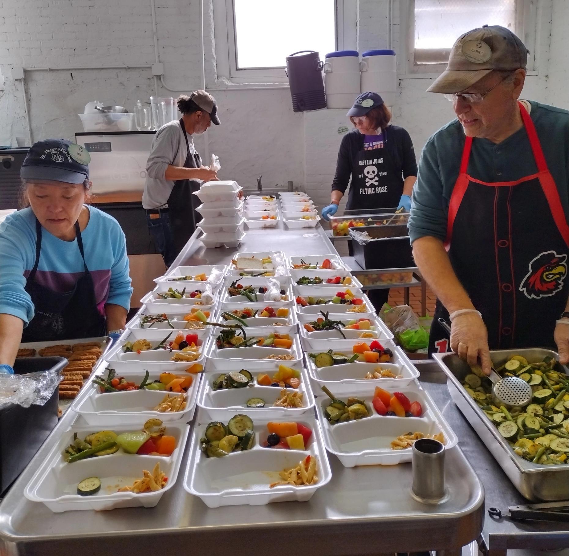 Busy volunteers at quick pace for all the hungry guests.