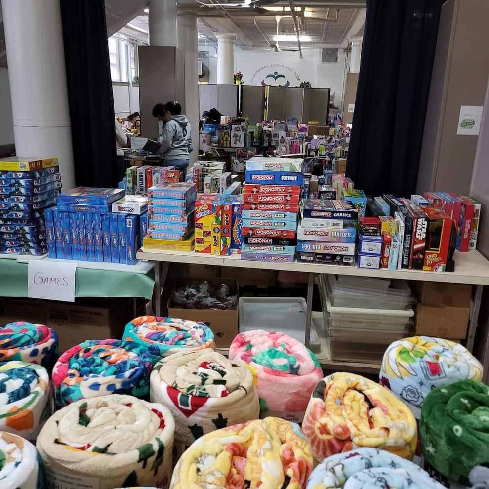 The dining room packed full of donated blankets, board games, and toys.