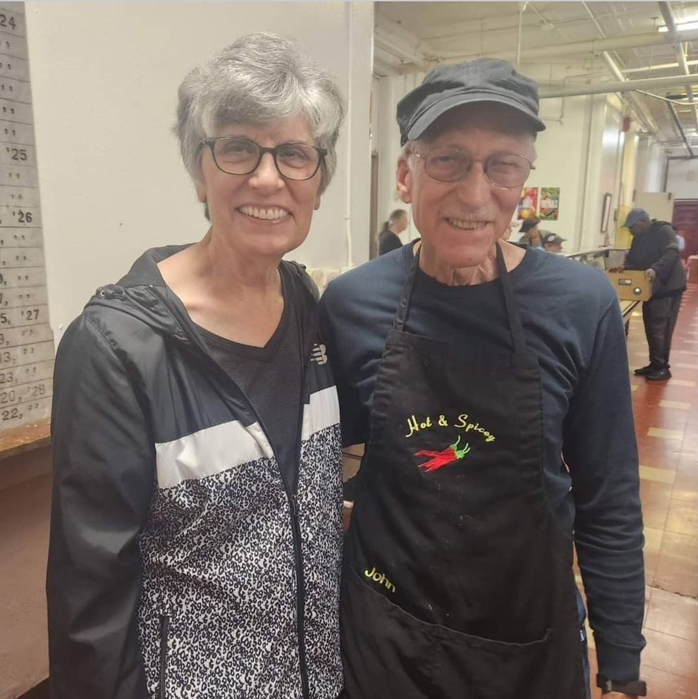 Two volunteers smile for the camera