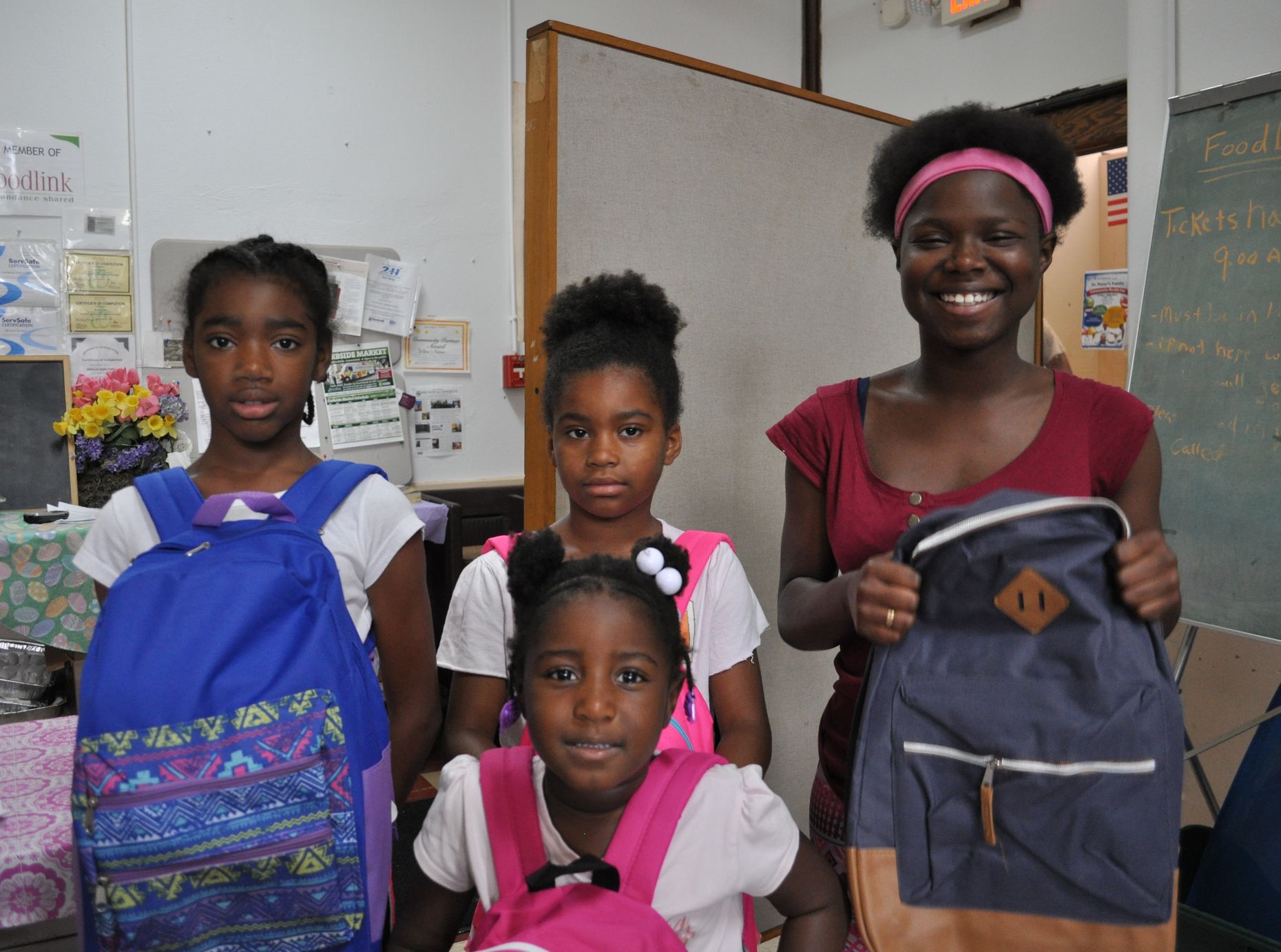 Four students with their new backpacks.