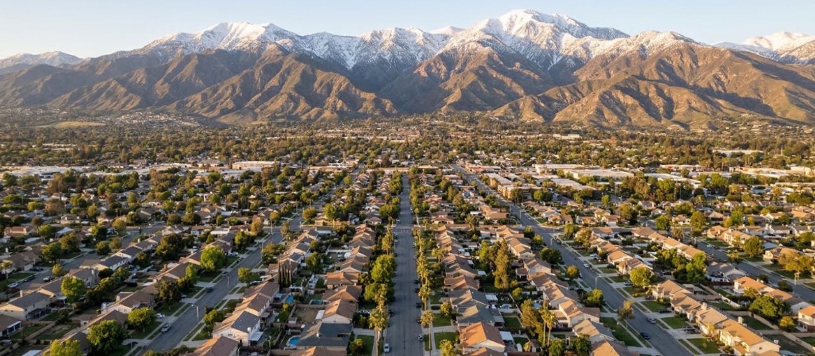 Aerial view of San Bernardino residential neighborhoods with San Bernardino Mountains