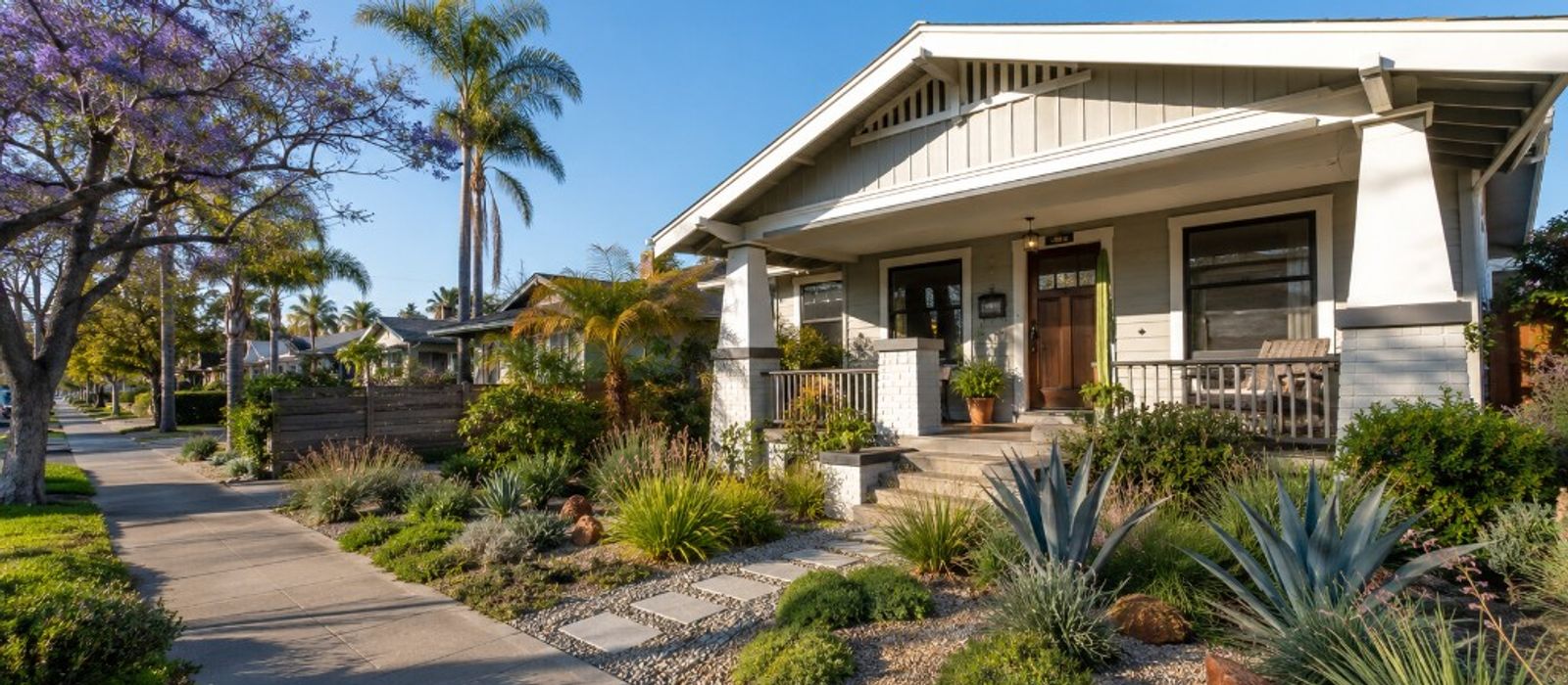 A Craftsman bungalow on a sunny residential street in North Park or City Heights, single story, mature trees, San Diego light.