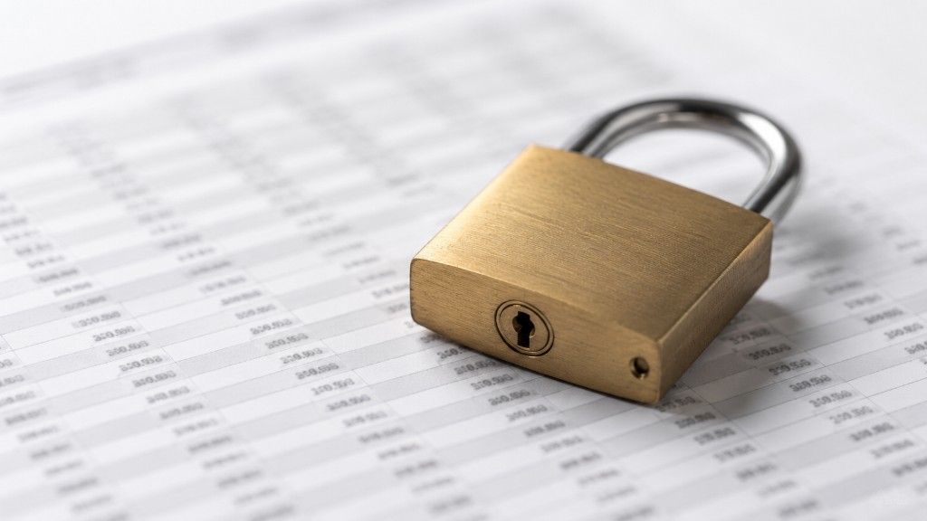 A padlock resting on a rate sheet representing a mortgage rate lock